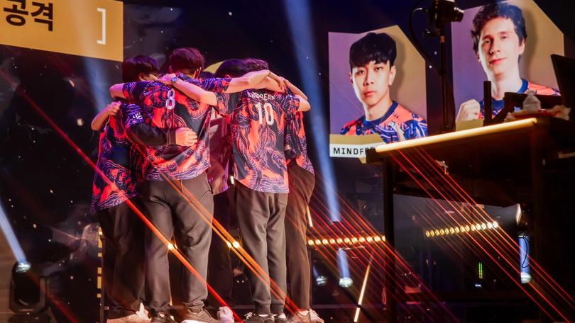 a group of people are hugging each other on a stage