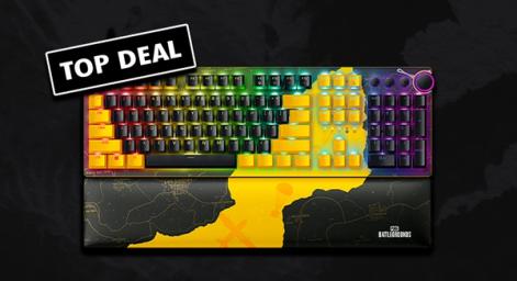 A Razer keyboard featuring multicolored lights behind the keys and a yellow and black pattern of the PUBG map across it. In the top left, a "TOP DEAL" label in black and white.