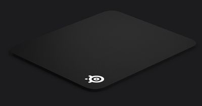 SteelSeries QCK Heavy product image of a black mouse pad featuring white SteelSeries branding.