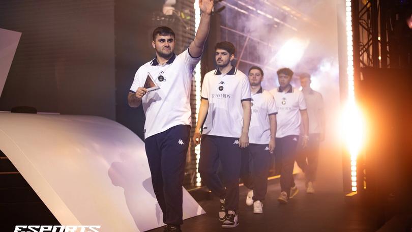 a group of men are walking down a stage .