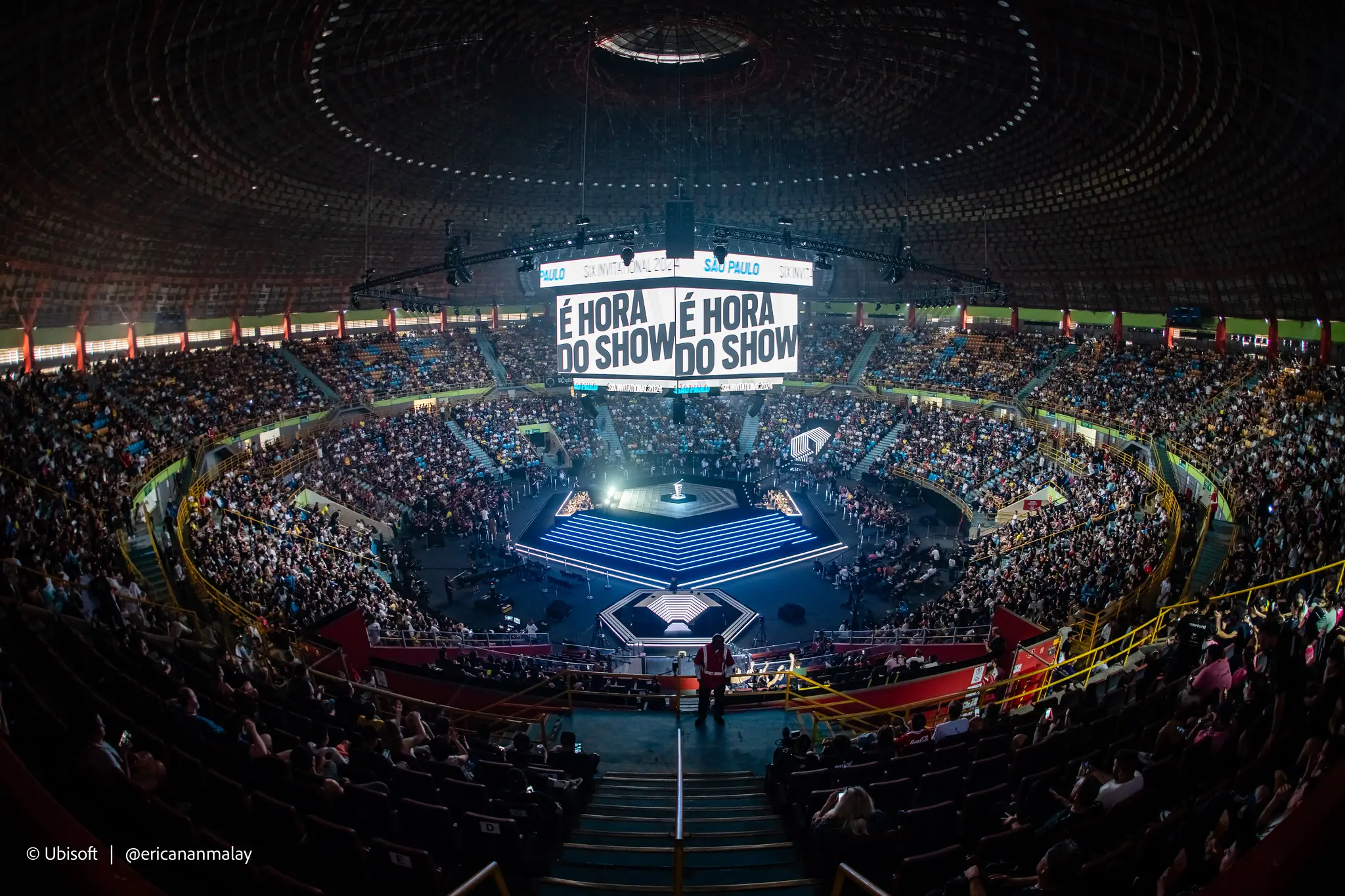 an aerial view of a stadium filled with people watching a show .