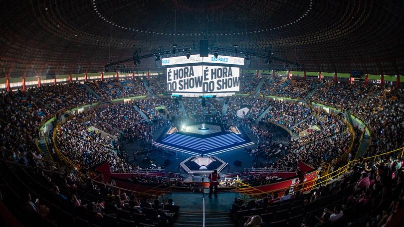 an aerial view of a stadium filled with people watching a show .