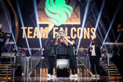 a group of men are standing on a stage holding a trophy .