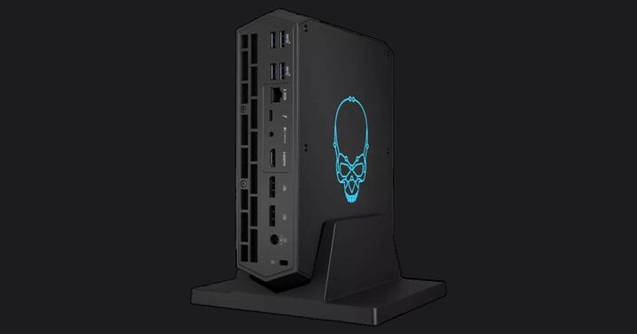 Intel NUC 12 product image of a black mini PC with a blue skull outline design lit up in blue on the side panel.