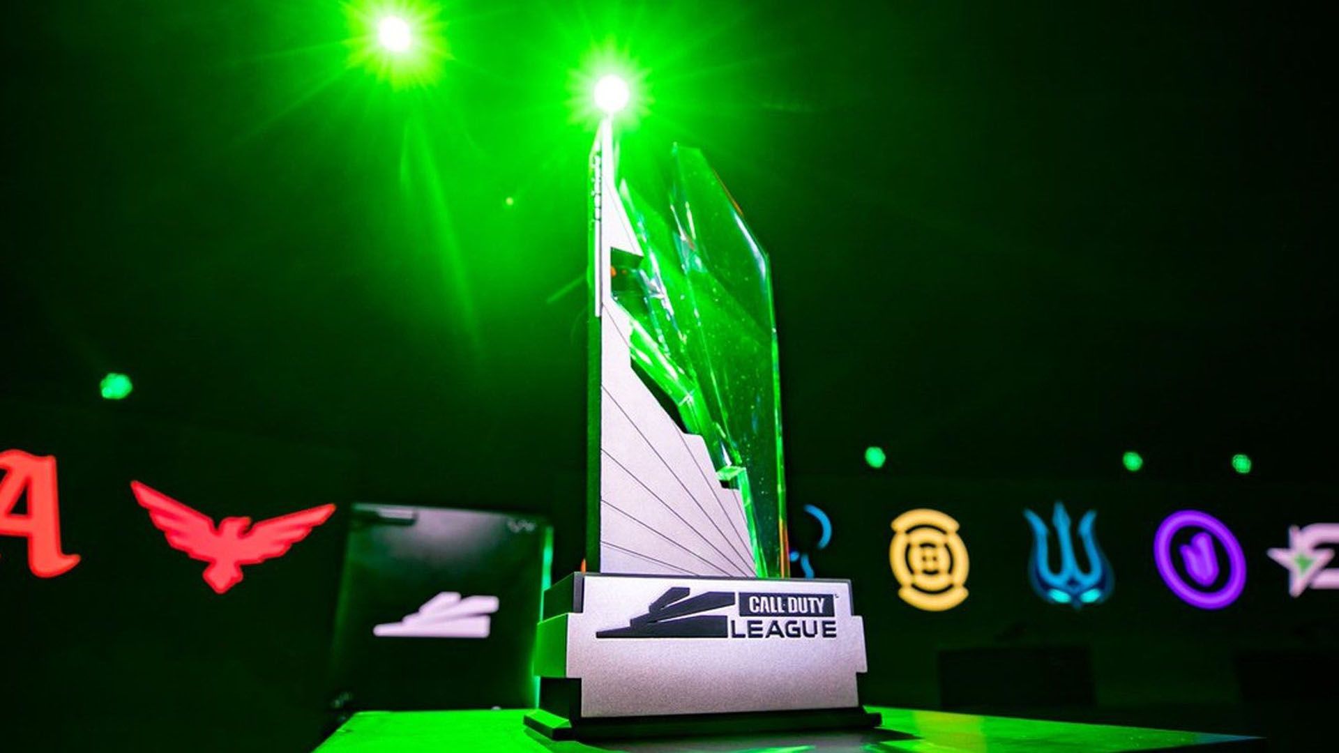 The Call of Duty League trophy highlighted by a green light. The logos of the 12 teams are in the background