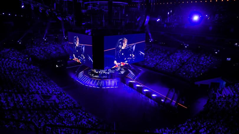 a large screen is displayed in the middle of a stadium .