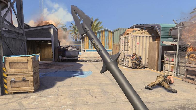 MW3 player holding a spear with another player crouched behind a shipping container in the background