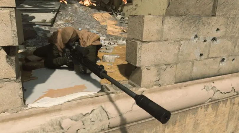 Warzone player aiming down sights of sniper rifle in hole between brick wall