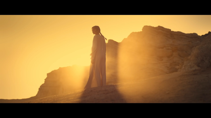 character stands on a rocky cliff