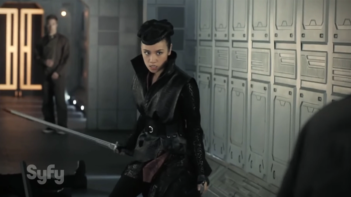 a female character stands brandishing a sword