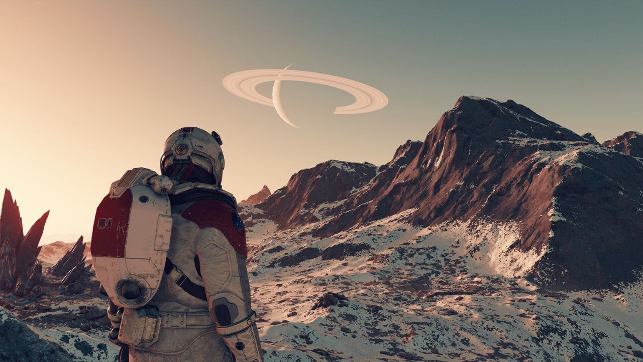 astronaut on a snowy world looks up at a nearby ringed planet