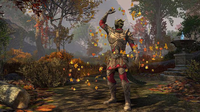 a man in armor is standing in a forest with leaves falling from the trees .