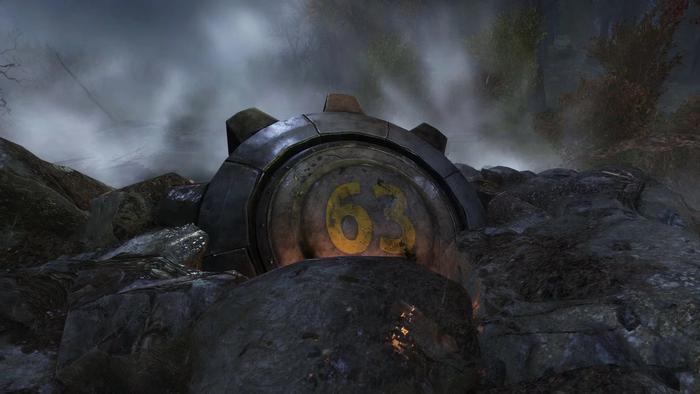 a vault door is sitting on top of a pile of rocks .