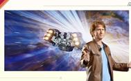 a man in a leather jacket is standing in front of a space ship in space .
