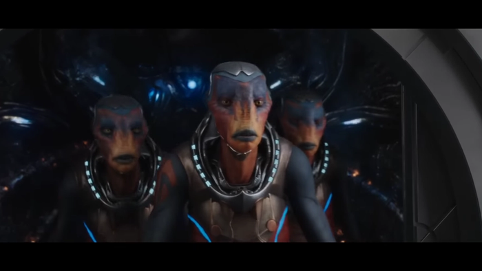 three aliens stand inside a ship