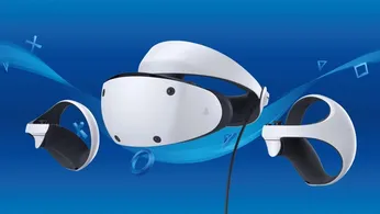 A white PSVR 2 headset next to the controllers in front of a PlayStation blue background