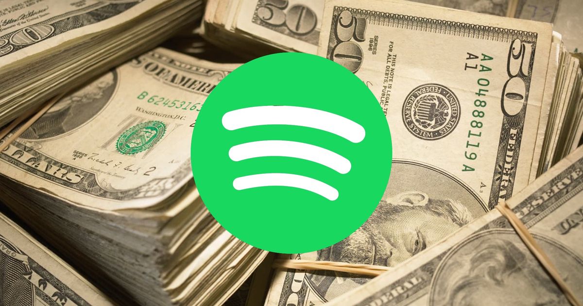 A pile of money behind the Spotify logo