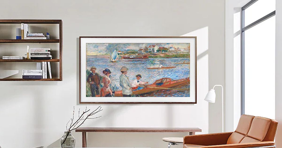 A living room with a Samsung The Frame TV on a cream wall that looks like a painting.