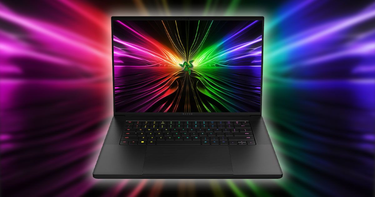 A black Razer laptop with multicolored lights on the display to match the background behind it.
