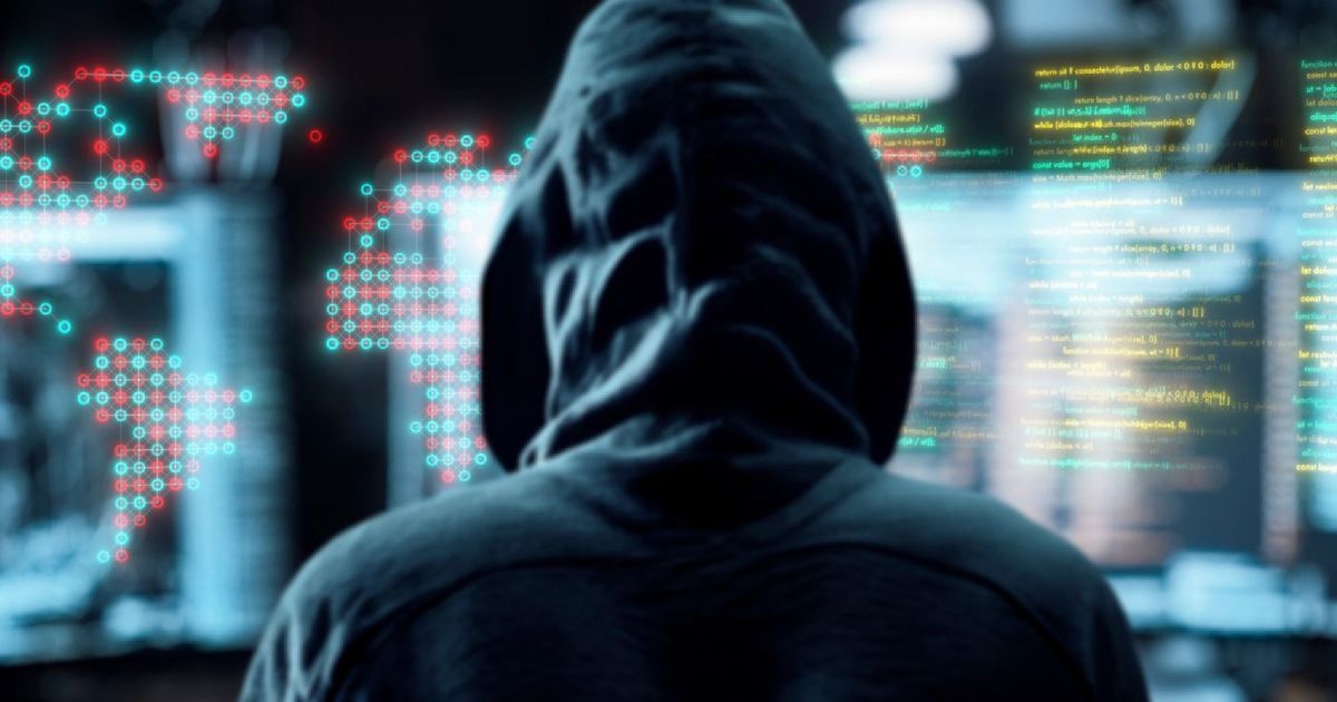 A hooded man looking at various augmented screens as an interpretation of hacking