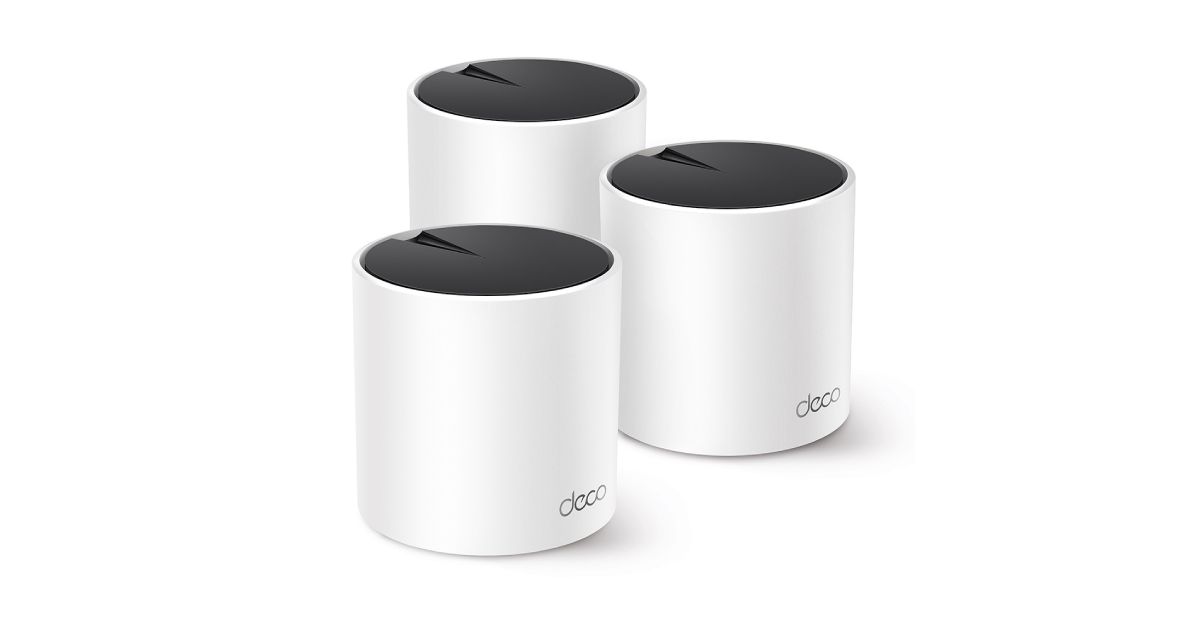 Three white cylindrical WiFi routers with black tops are sitting next to each other.