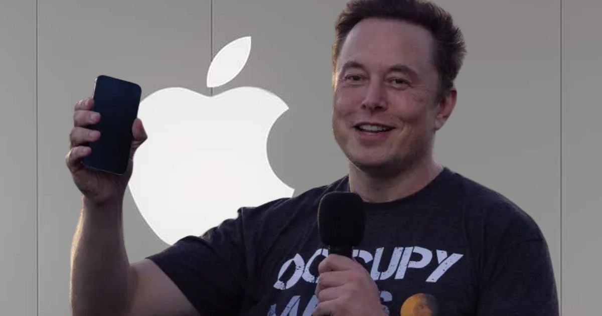 Elon Musk holding a smartphone and wearing an Occupy Mars shirt in front of an Apple Store logo