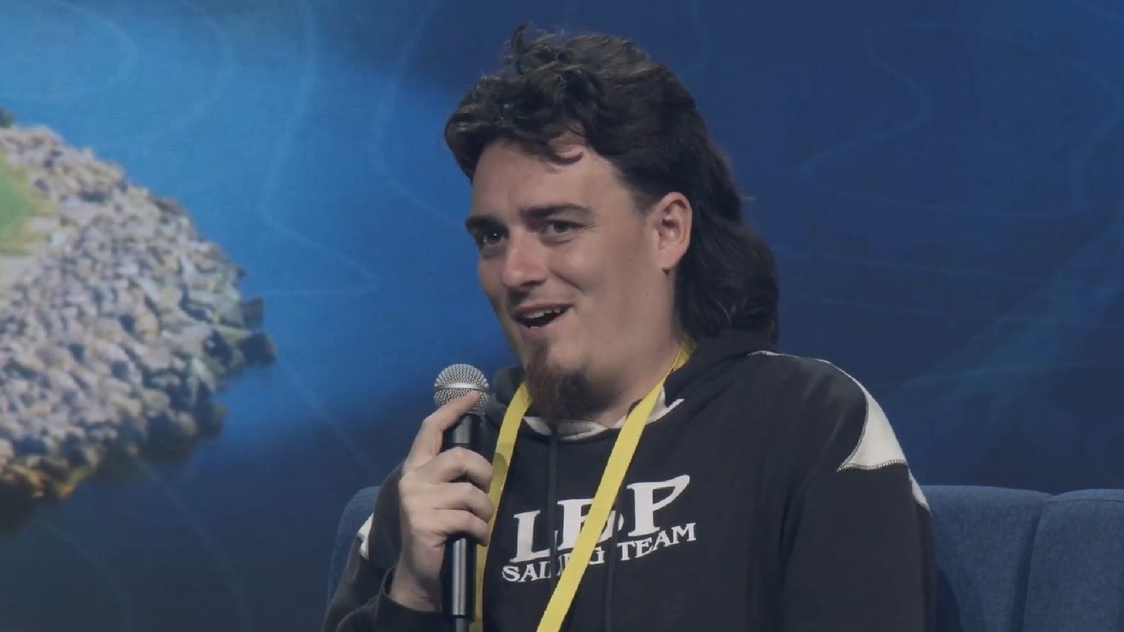Palmer Luckey, founder of Oculus, holding a microphone and speaking on-stage